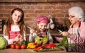 Grandmother and grandkids cooking salad Royalty Free Stock Photo