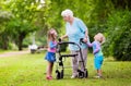 Grandmother with walker playing with two kids Royalty Free Stock Photo