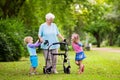 Grandmother with walker playing with two kids Royalty Free Stock Photo