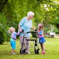 Grandmother with walker playing with two kids Royalty Free Stock Photo