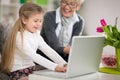 Grandmother watching granddaughter using laptop Royalty Free Stock Photo