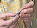 Grandmothers hands crochet blue thread. Closeup clip of senior woman crocheting