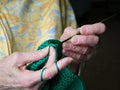 Grandmothers hands crochet green yarn. Closeup clip of senior woman crocheting