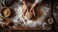 Grandmothers hands expertly kneading bread dough on a wooden table