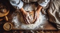 Grandmothers hands expertly kneading bread dough on a wooden table