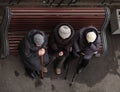 Grandmothers sit on a bench and talk