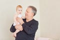 Grandpa with a baby granddaughter in her arms. Royalty Free Stock Photo