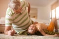 Grandpa and granddaughter playing.