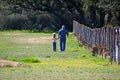 Grandpa and granddaughter talking in the pasture