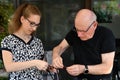 Granddaughter helps her grandfather to unravel a chain
