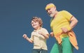 Grandpa and grandson exercising on blue sky. Cheerful grandpa and cute child grandson jogging in sportswear on sky Royalty Free Stock Photo