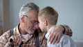 Grandpa and grandson leaning foreheads together, family love, sentimentality Royalty Free Stock Photo