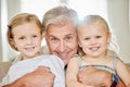 A man should never neglect his family for business. a grandpa and his granddaughters at home. Royalty Free Stock Photo