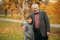 Grandpa and his grandson are walking in the park. The spend time together Royalty Free Stock Photo