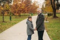 Grandpa and his grandson are walking in the park. The spend time together Royalty Free Stock Photo