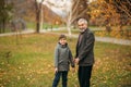 Grandpa and his grandson are walking in the park. The spend time together Royalty Free Stock Photo