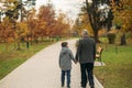 Grandpa and his grandson are walking in the park. The spend time together Royalty Free Stock Photo