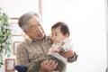 Grandpa holding his great-grandson