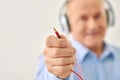 Grandpa keeps cord from headset Royalty Free Stock Photo