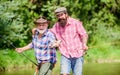 Grandpa and mature man friends. Fishing with spinning reel. Sunny summer day at river. Fisherman family. Hobby sport Royalty Free Stock Photo