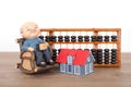 Grandpa model and small house model and calculation tool abacus Royalty Free Stock Photo