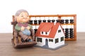 Grandpa model and small house model and calculation tool abacus Royalty Free Stock Photo