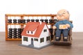 Old grandpa model and grandma model and small house model and calculation tool abacusGrandpa model and small house model and calcu Royalty Free Stock Photo