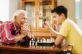 Grandpa Playing Chess Board Game With Grandson At Home Royalty Free Stock Photo