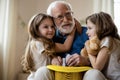 Grandpa playing with kids and looking inspired stock photo