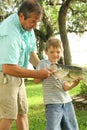 Grandpa showing how to hold a fish