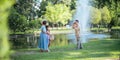 Grandpa takes pictures of granddaughter and grandma with his in park on sunny day happiness. concept grandparent and Royalty Free Stock Photo