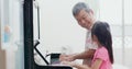 Grandpa teach girl play piano