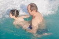 Grandpa teaches grandson to swim