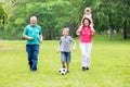 Grandparent And Grandchildren Playing Soccer Ball Together Royalty Free Stock Photo