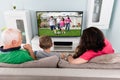 Grandparent And Grandchildren Watching Television Together Royalty Free Stock Photo
