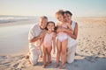 Grandparents with children, happy on beach on holiday and enjoying retirement. Grandpa, grandma and kids enjoy afternoon