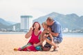 Grandparents enjoying day with granddaughter while blowing soap bubbles on the beach near the sea Royalty Free Stock Photo