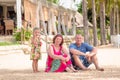 Grandparents enjoying day with granddaughter while blowing soap bubbles on the beach near the sea Royalty Free Stock Photo