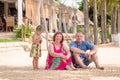 Grandparents enjoying day with granddaughter while blowing soap bubbles on the beach near the sea Royalty Free Stock Photo