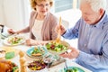 Grandparents Enjoying Food at Family Dinner Royalty Free Stock Photo