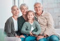 Grandparents, girl and mother in portrait on sofa with hug, care or bonding with love in family home lounge. Elderly