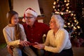 Grandparents giving gifts granddaughter at Christmas eve Royalty Free Stock Photo