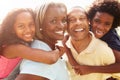 Grandparents Giving Grandchildren Piggyback Ride In Garden Royalty Free Stock Photo