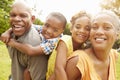 Grandparents Giving Grandchildren Piggyback Ride In Garden Royalty Free Stock Photo