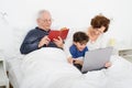 Grandparents grandchild bed laptop Royalty Free Stock Photo