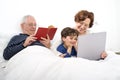 Grandparents grandchild bed laptop Royalty Free Stock Photo