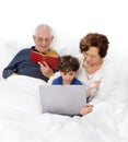 Grandparents grandchild bed laptop Royalty Free Stock Photo
