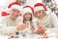 Grandparents with grandchild preparing for Christmas Royalty Free Stock Photo