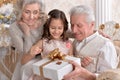Grandparents with grandchild preparing for Christmas together Royalty Free Stock Photo