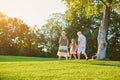 Grandparents and grandchild walking outdoors. Royalty Free Stock Photo